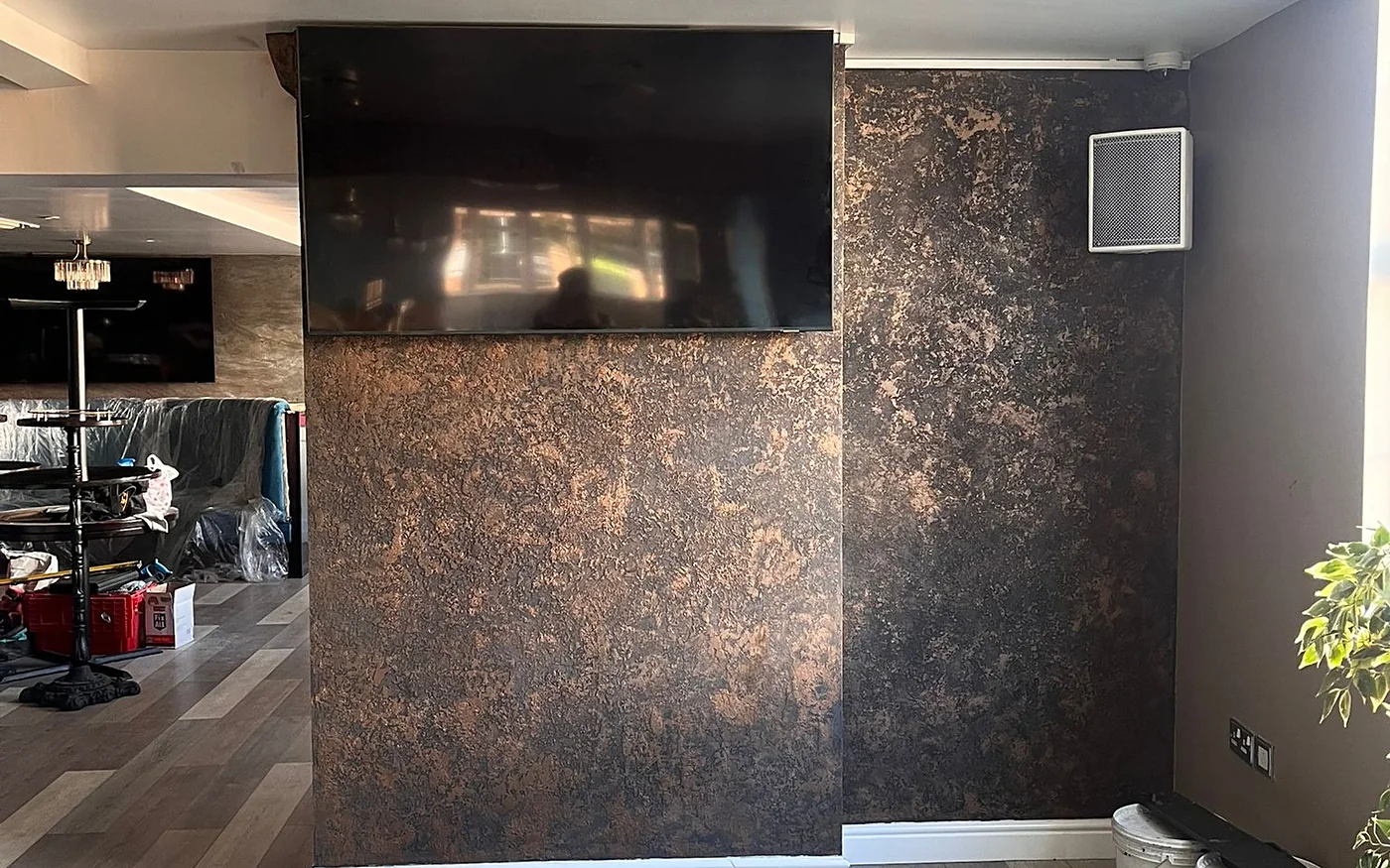 Nightclub feature wall in black and bronze textured plaster