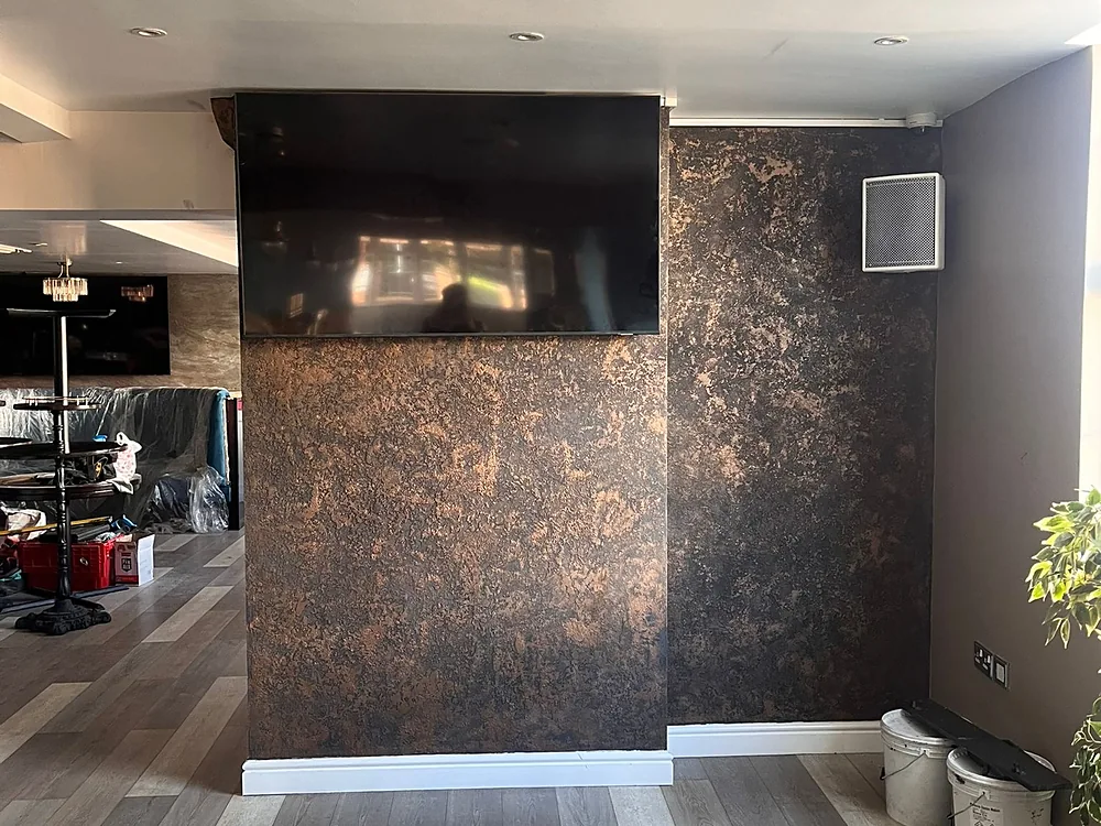 Nightclub feature wall in black and bronze textured plaster