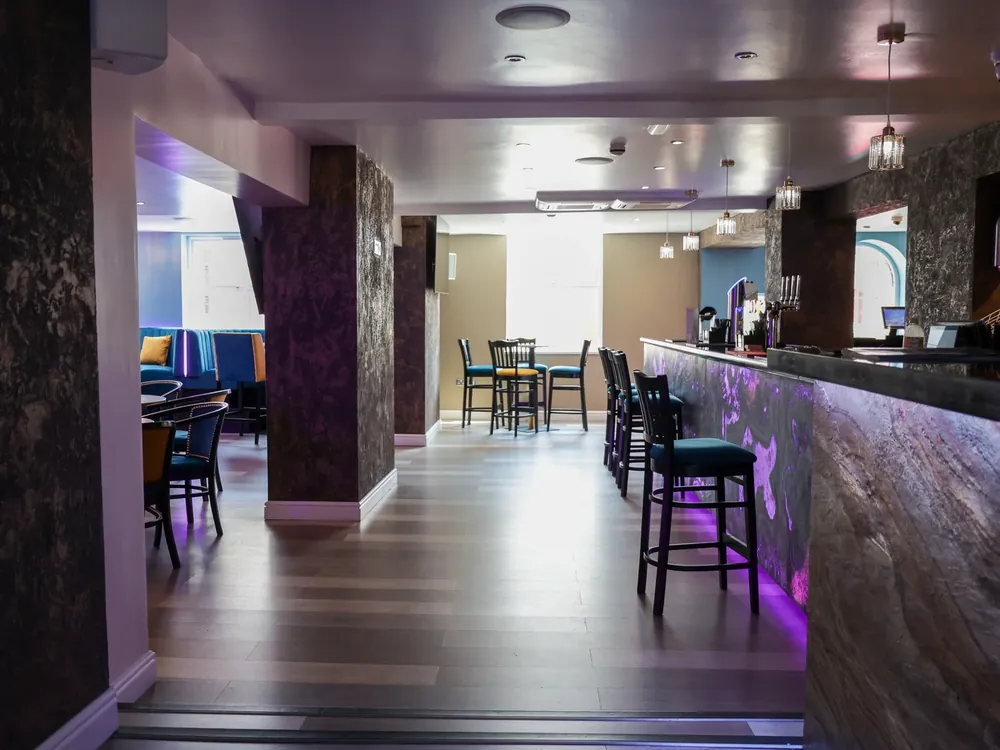 Nightclub in black and bronze textured plaster bar front